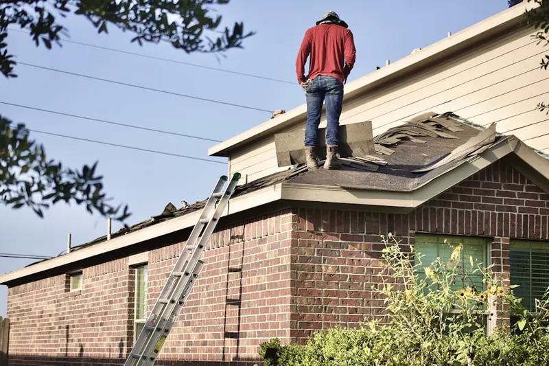 Professional roofer working on a residential roof in Twin Pines